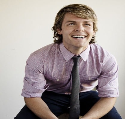 lachlan wearing purple shirt with a black tie. 